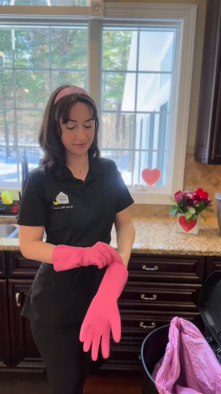 Cleaner pulling on a signature pink glove