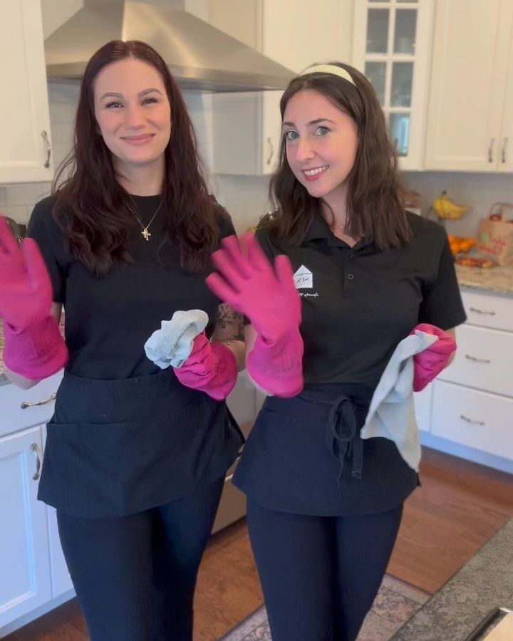 Squeaky Clean Services team in branded uniform with signature pink gloves, ready to clean a client kitchen